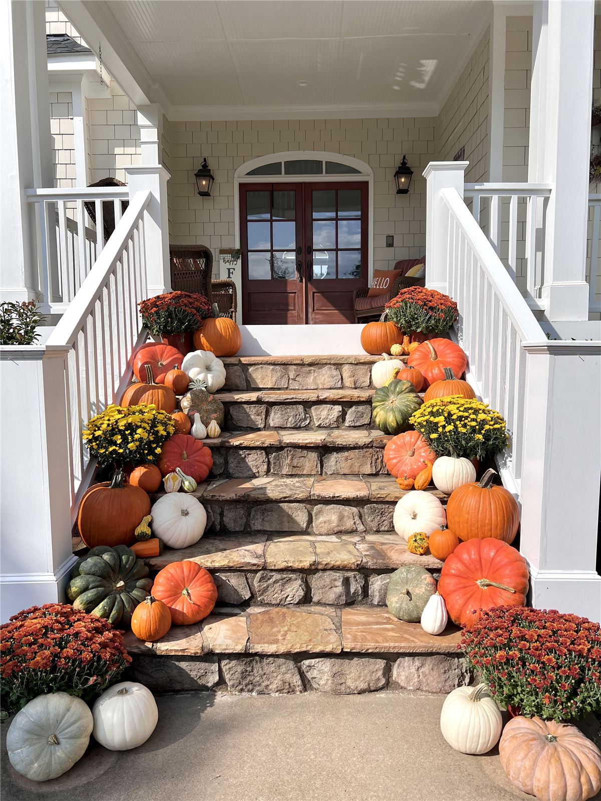 Fall porch display on stone steps with pumpkins and mums, Raleigh NC